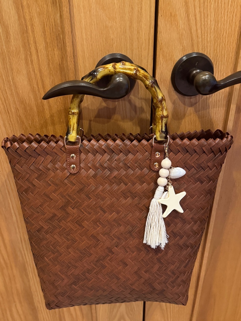 NWT Tommy Bahama woven tote bag, charm included.